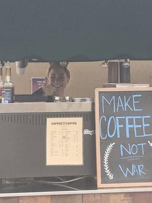 A cheerful barista at Coffee Coffee, unlike the previous owner who often was a bit grumpy.