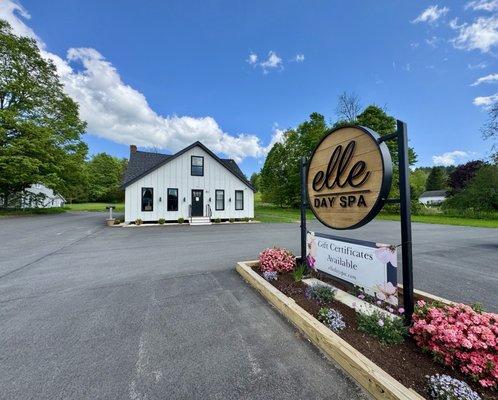 Outside of Elle Day Spa building and sign, lots of parking