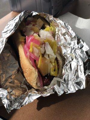 Polish dog with bodacious sauce, and all the toppings (except sweet relish): onions, jalapeños, banana peppers, neon pink onions, pineapple.