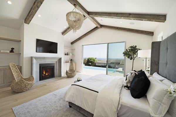 Add a gas fireplace with natural looking logs to create a focal point in a bedroom