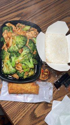Chicken and broccoli with white rice and an egg roll