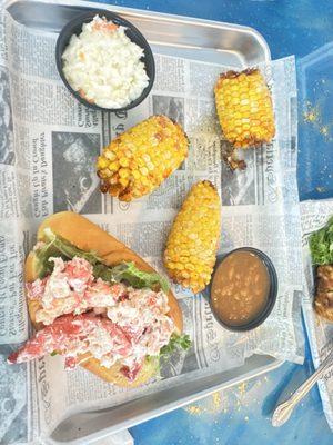 New England lobster roll with fried corn on the cob.