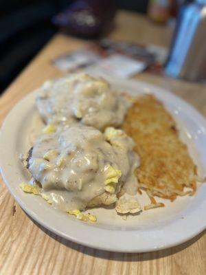 Country Benedict- 2 hand-cracked scrambled eggs & 2 sausage patties on a split buttermilk biscuit covered with sausage gravy & hash browns