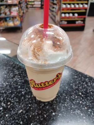 Eggnog milkshake with whipped cream and cinnamon on top.