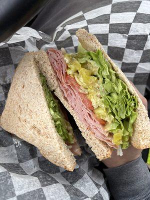 Brown sugar ham sandwich with everything on it.