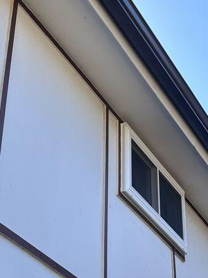 Windows installed halfway outside house.