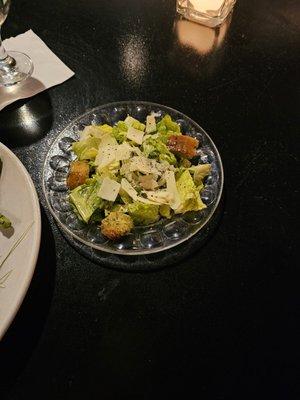 Caesar salad with homemade croutons and fresh parmesan slices.