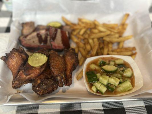 Two piece meat platter: brisket, wings, fries, cucumber salad