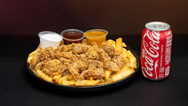 Savory fried liver bites served with golden fries, sauces, and Coca-Cola.