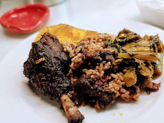 Jerk chicken with rice and peas, collards, and meat pie