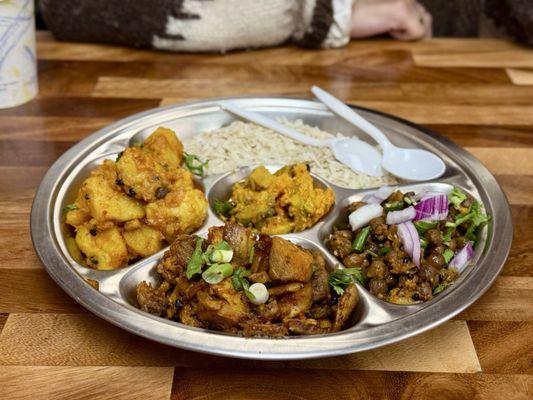 Chhoila Samayabajee - spiced meat, spicy potatoes, chickpeas, bitter melon salad, and toasted flattened rice