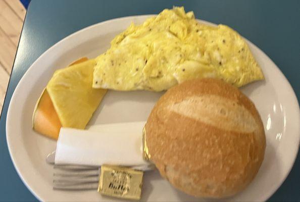 Tomato Herb Omelette three eggs served with fruit and roll.