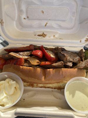 Steak sandwich with peppers and onions.