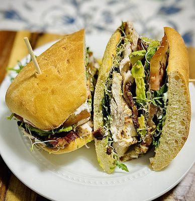 Carving Board Club. Roasted in-house and hand carved turkey, maple bacon, avocado, tomato, herb remoulade, sprouts, & arugula on Pizzabatta.
