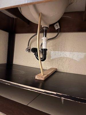 Sink being held up by a stick?
