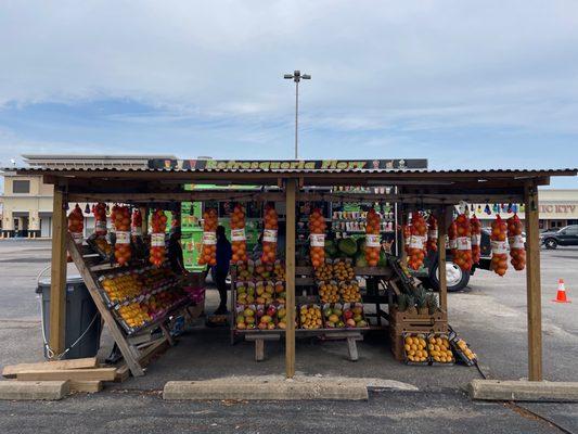 Front side of the truck plus a fruit stand