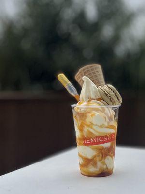 Mangocaron: Milk Ice Cream Base with Homemade Mango Syrup, Macaron garnish on top & Cone | $7.85