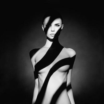 Art nude. A figure without clothes, with an original shadow pattern on the body. Shooting price from $900