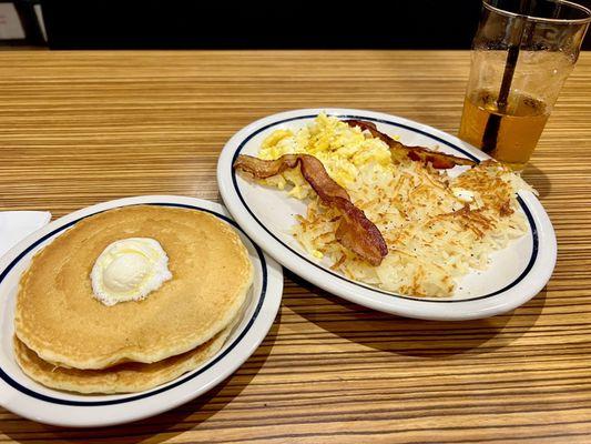 Breakfast Sampler -- Scrambled Eggs, Bacon & Hash browns with two Pancakes.