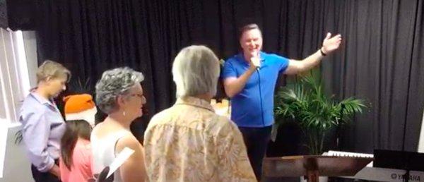 Rev. Jonathan leads the community in song at a Sunday Gathering.