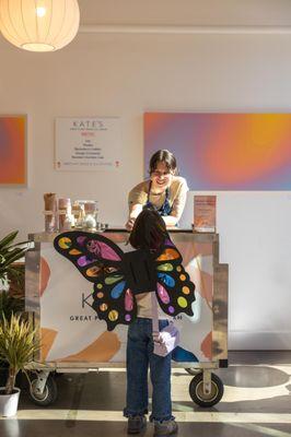 Kate's Ice Cream employee serving customer ice cream.