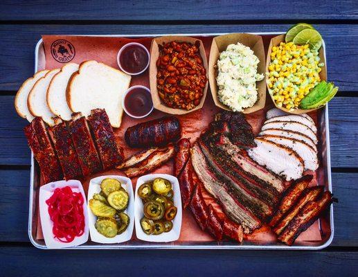 This is a gigantic display of BBQ from turkey breast, brisket, house cured bacon, St. Louis pork ribs, sausage, armadillo eggs