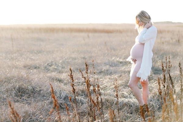 Dreamy backlighting in an open field up the coast of highway one for this maternity session.