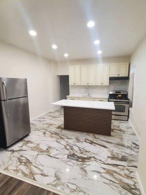 Flooring, cabinets, light fixtures, and custom kitchen island. Full kitchen reno by SAT Design Reno