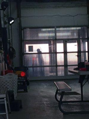 Tidy empty break room, young men busy working.