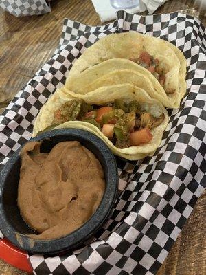 Tacos, side of crusted over refried beans.