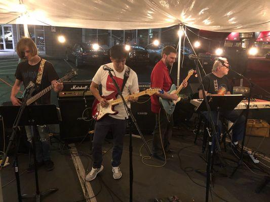 Kyle McCann performing with his students