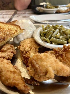 Chicken strips, green beans, mashed potatoes with pepper gravy, garlic bread.