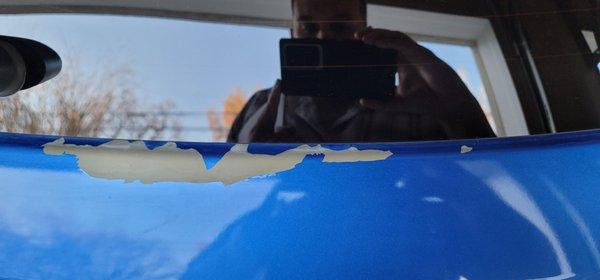 Paint that was removed from rear hatch by the car wash.