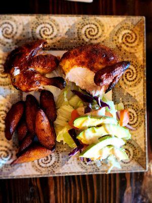 Half chicken with fried sweet plantains, and avocado salad.