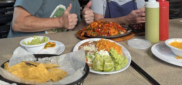 Combo Fajitas, with sides plate, chips, guac, and queso (cut off in left side of photo.