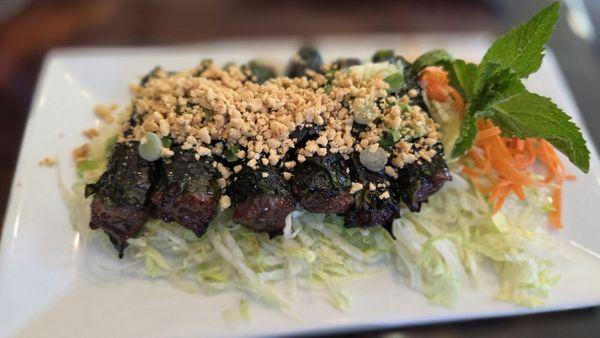 Grilled Betel Leaf Rolls on a bed of greens. I like mine dipped in Sriracha.