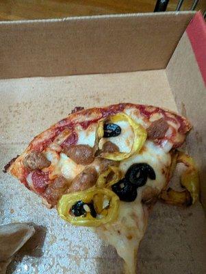 Pizza showing the edge with nothing but sauce on the crust because there was so much.