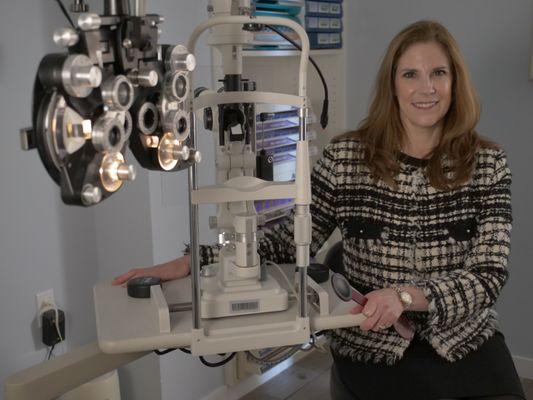 Dr. Blas in her state-of-the-art exam room at Eyes in Disguise Optometry. Experience unparalleled eye care with a personal touch.