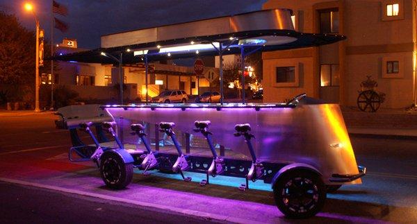 The party bike lit up at night