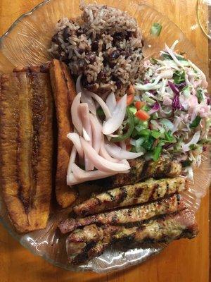 Carne asada made with pork, sweet plantains, cabbage salad and rice and beans. Yum!