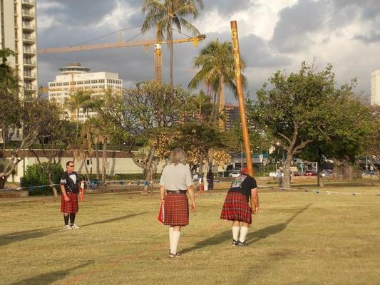 Caber Toss on the back lawn at McCoy Pavillion