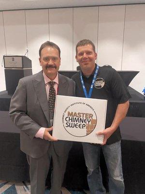 Steve Trumble receiving Master Chimney Sweep Certificate from the CSIA.