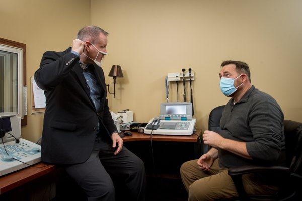 Dr. Larsen explaining hearing loss to a patient