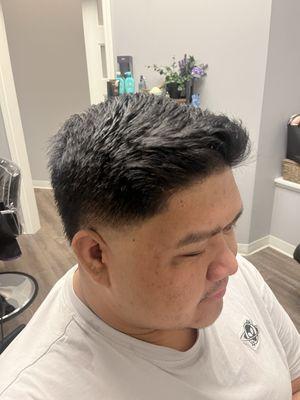 Clean taper fade, kept the length on top, finished with a clean up