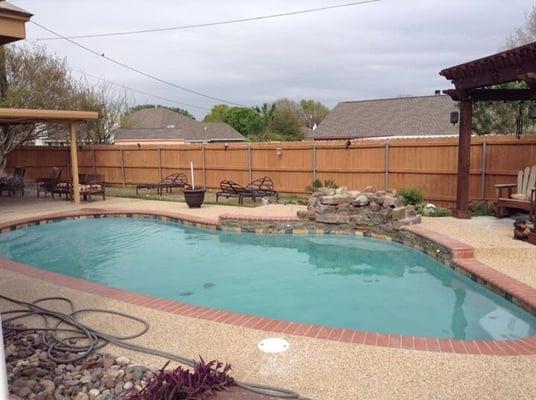 After: multi color tile, Cayman lagoon plaster finish, rust gray ledge stone, new moss rock water fall