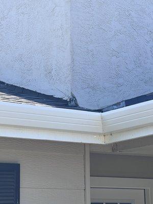 Large area broken stucco and you can see it was cut by the blade marks.