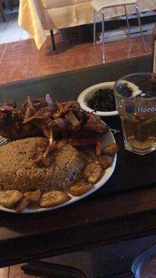 Grilled Fowl served with rice and plantain. Served with a side of snails and a cold beer imported from Cameroon!