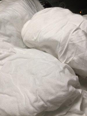 The results of washing the very same White quilt at home immediately after.