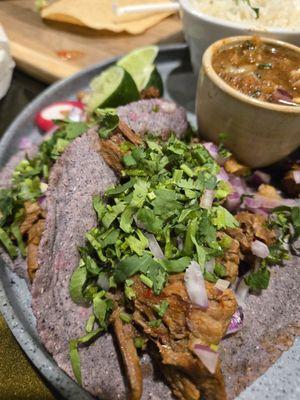 Barbacoa tacos on blue tortillas