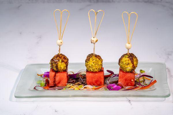 Watermelon & Pistachio-Crusted Goat Cheese with shaved red onion and chocolate balsamic